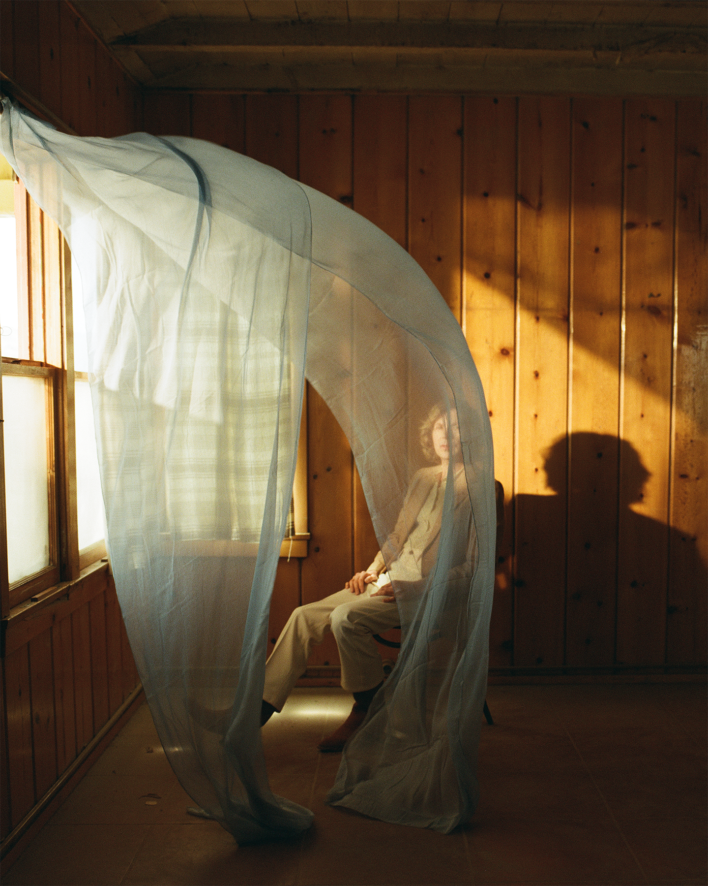 Ride Lonesome album artwork of Beck sitting in a chair near an open window